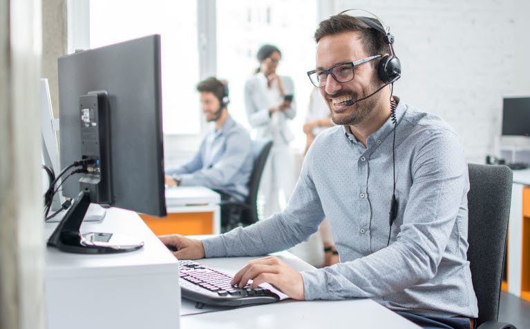 Smiling,Customer,Support,Operator,With,Hands free,Headset,Working,In,The